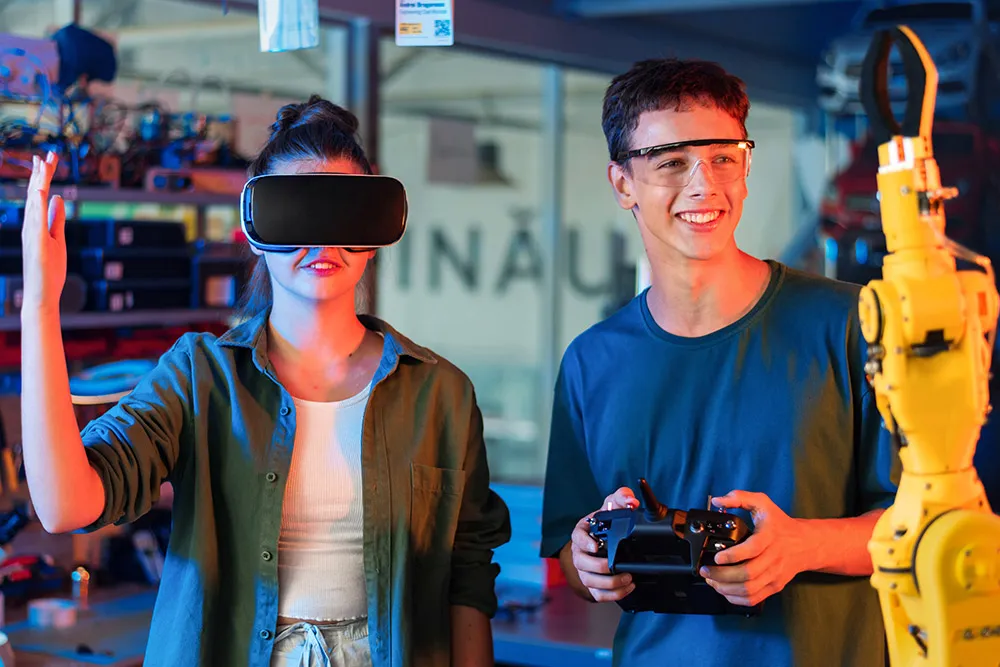 Innovative students using a robotic arm and virtual reality goggles